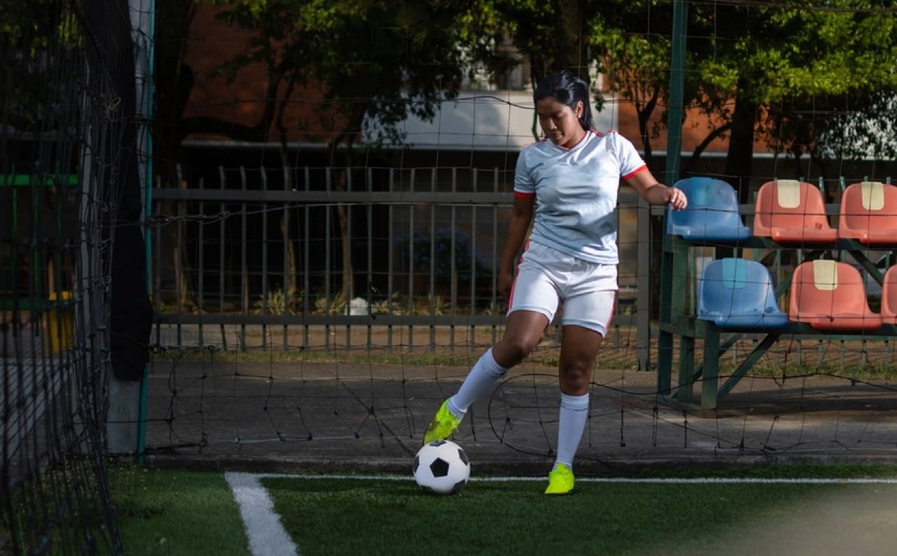 Football athlete training with a ball